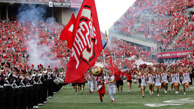 Brutus leads the Ohio State Buckeyes through the tunnel in front of a capacity crowd at Ohio Stadium